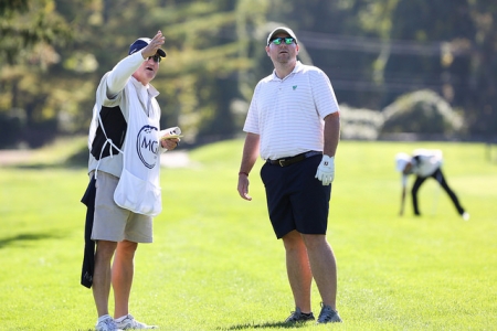 Golfer discussing the game with a caddie